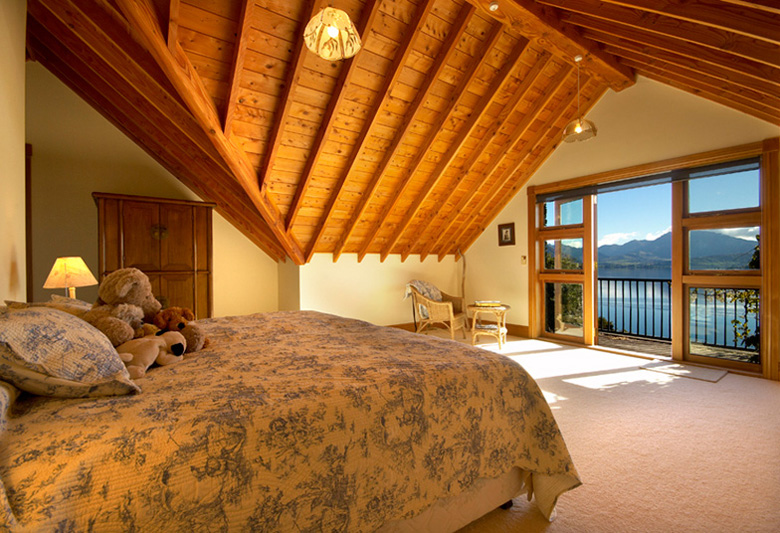 Beedroom with wood ceiling and balcony over looking Lake Wanaka