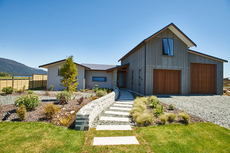 Garage view of Te Anau house with walkway to door