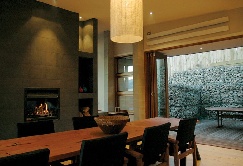 View from the dinning table looking towards fireplace and out to courtyard