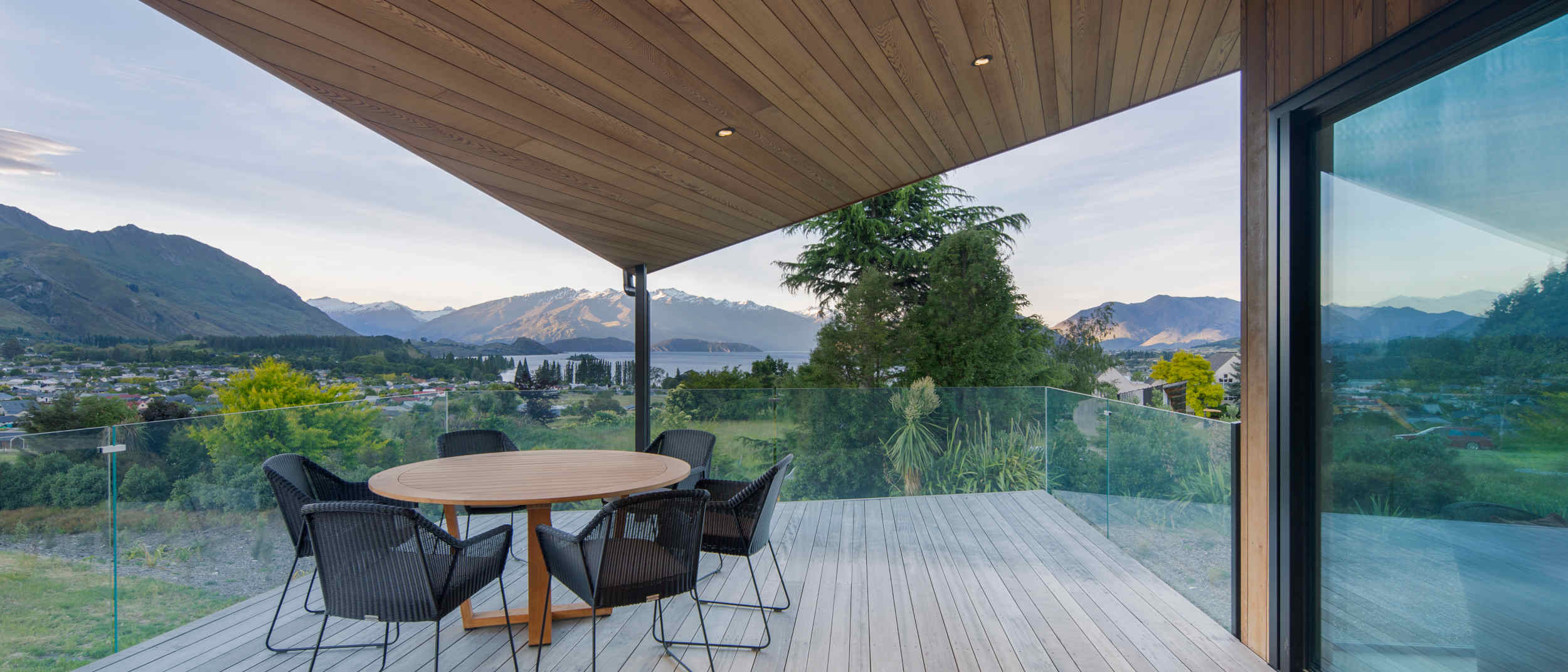 Outdoor living space featuring a Purpleheart hardwood deck and a warm cedar ceiling, creating a seamless and inviting connection between indoor and outdoor areas.