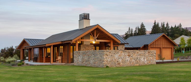 View from lawn at dusk highlighting stone wall