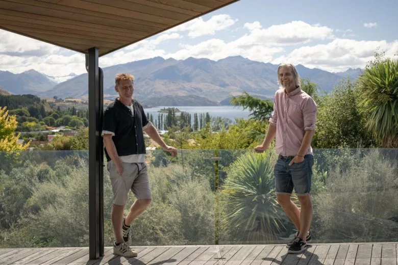 Steve and Mike standing on a balcony overlooking Lake Wanaka