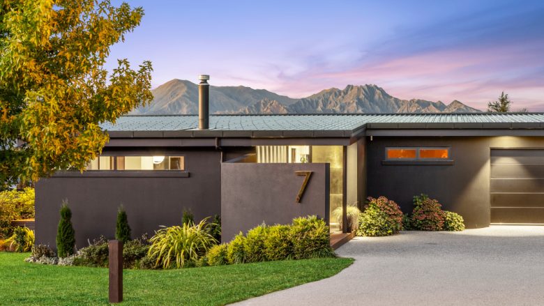 Entry to Diamond House, showcasing a sleek façade and a warm, sheltered entrance that sets the tone for the refined spaces within.