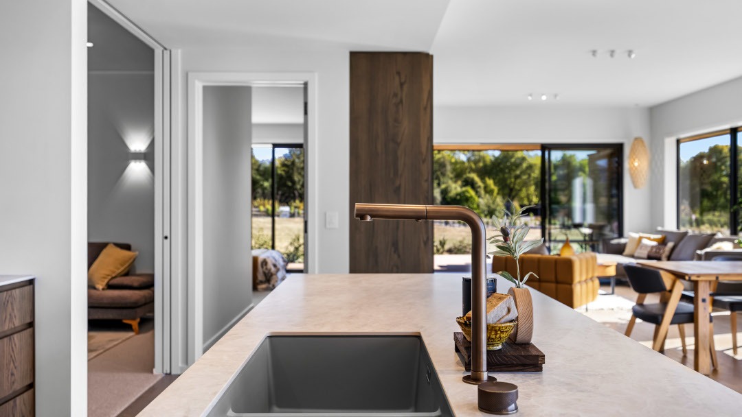 Looking across the kitchen sink toward the media room, with a view to the master bedroom in the background