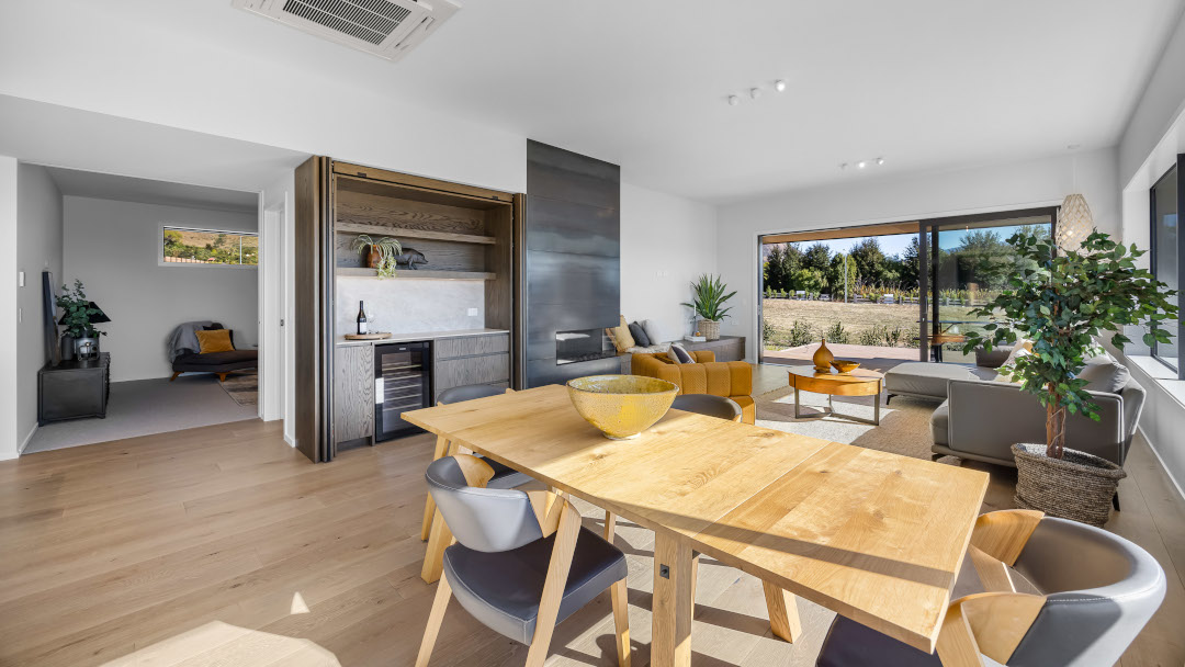 View through the dining area to the media room in a contemporary open-plan home.