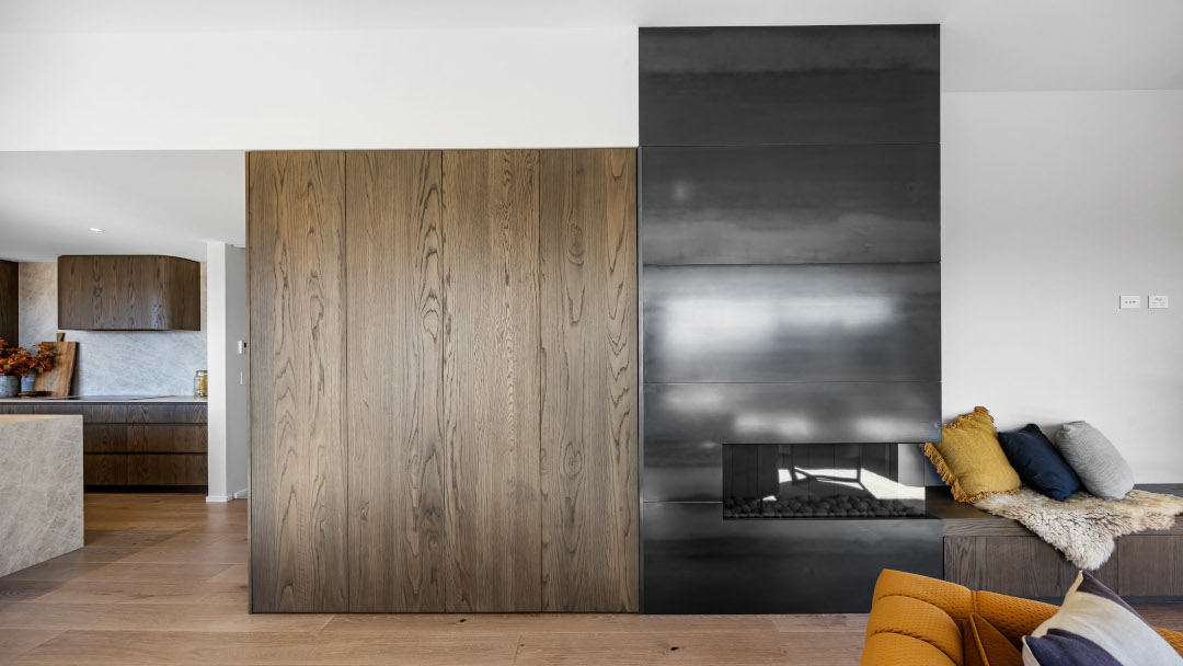 Stunning interior with a rich colour palette and layered textures, featuring a contemporary gas fire.