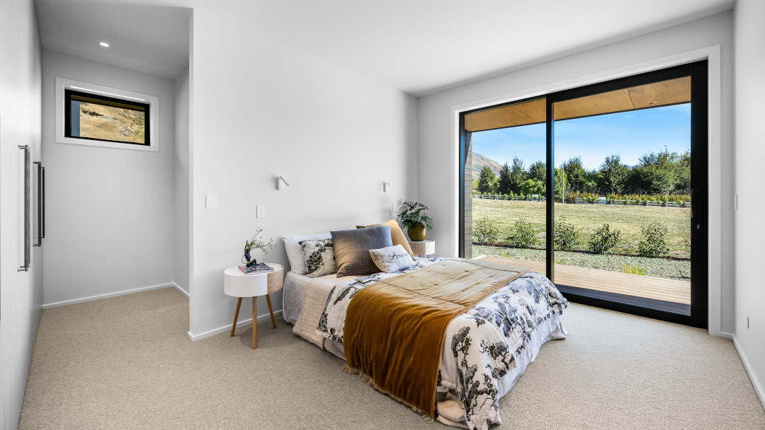 Private master suite with large sliding glass doors to a sunny deck