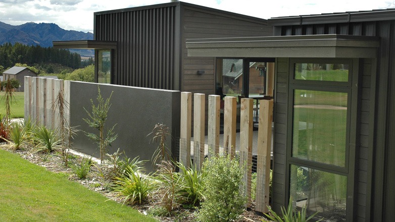 Looking through a fence into an internal courtyard, with views extending through to the living area beyond.