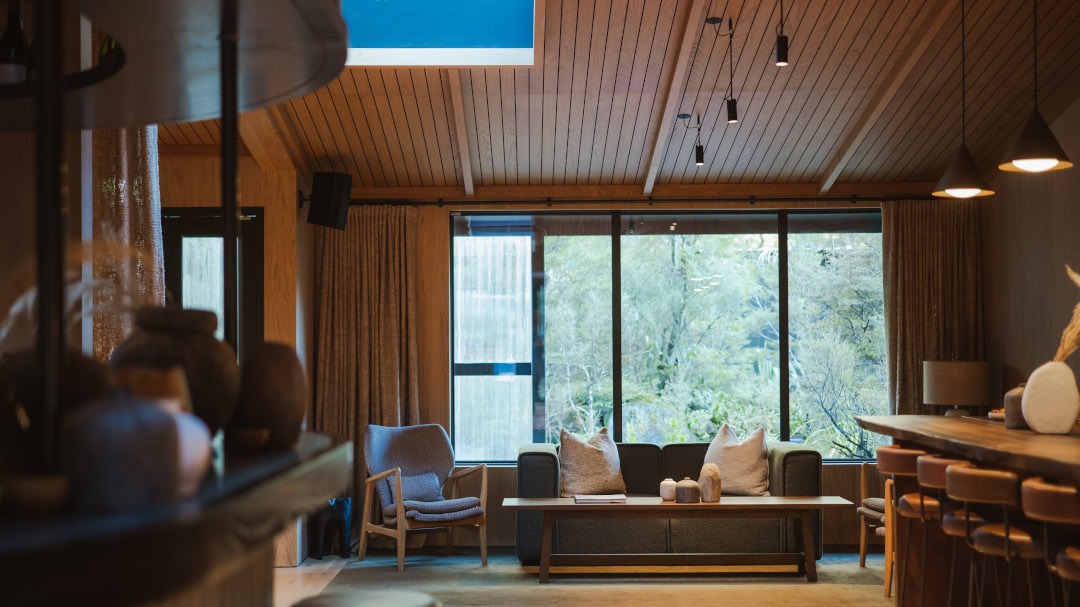 Lounge area with timber-lined ceilings and walls, creating a warm, natural interior atmosphere.