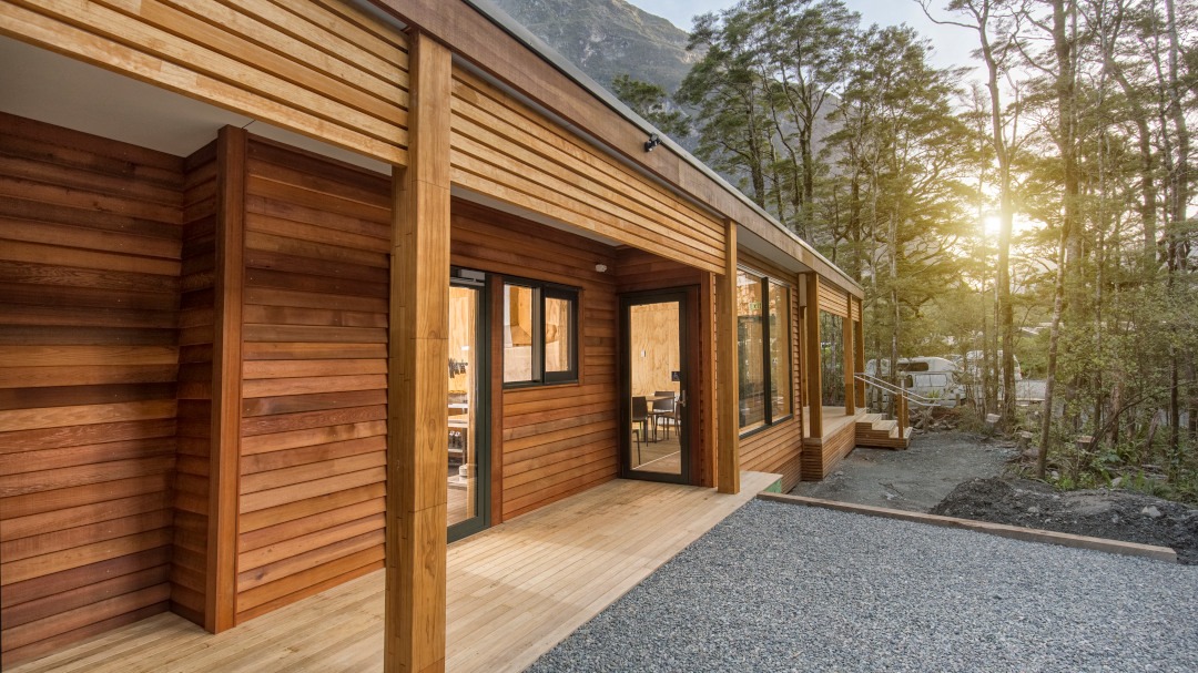 Cedar-clad amenities building set within a natural landscape, featuring contemporary design and warm timber exterior finishes.